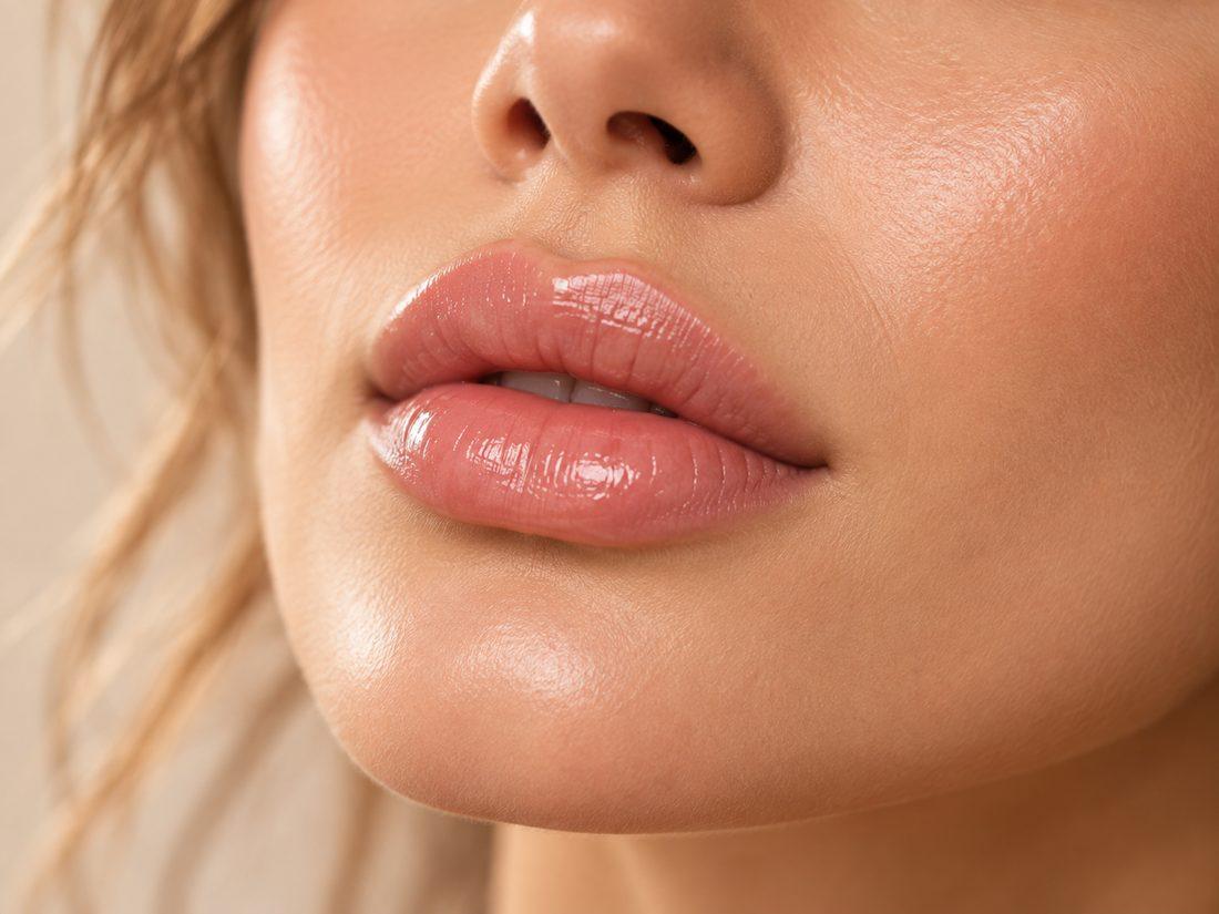 Close-up of naturally full, softly glossed lips